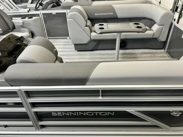 Slide: The Image of 2025 Bennington 22 SSB pontoon boat interior with gray seating and cup holders. - 11