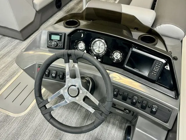 Slide: The Image of 2025 Bennington 22 SSB boat dashboard with steering wheel, gauges, and control panel. - 4