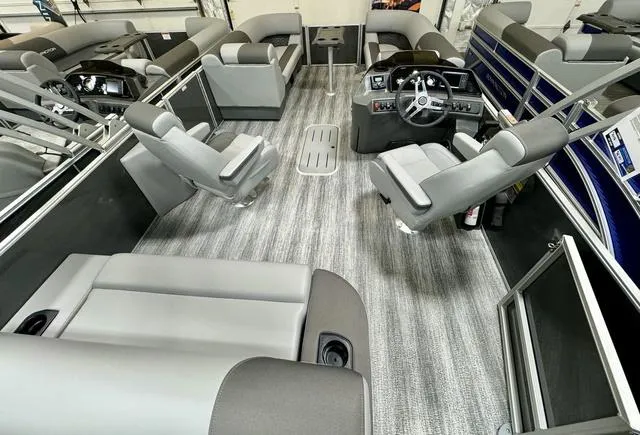 Slide: The Image of 2025 Bennington 22 SSB pontoon boat interior with modern seating and steering console. - 5