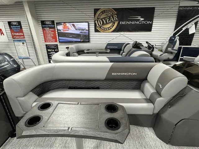 Slide: The Image of 2025 Bennington 23 SSB pontoon boat interior with seating and table, showroom display. - 17