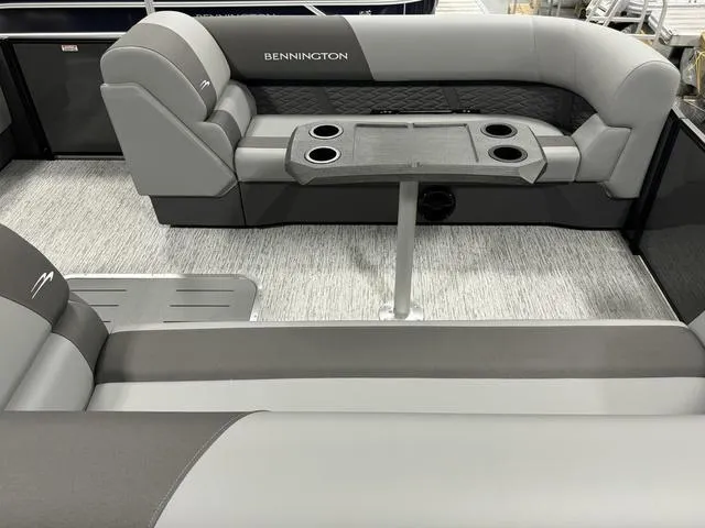 Slide: The Image of 2025 Bennington 23 SSB pontoon boat interior with gray seating and table. - 20