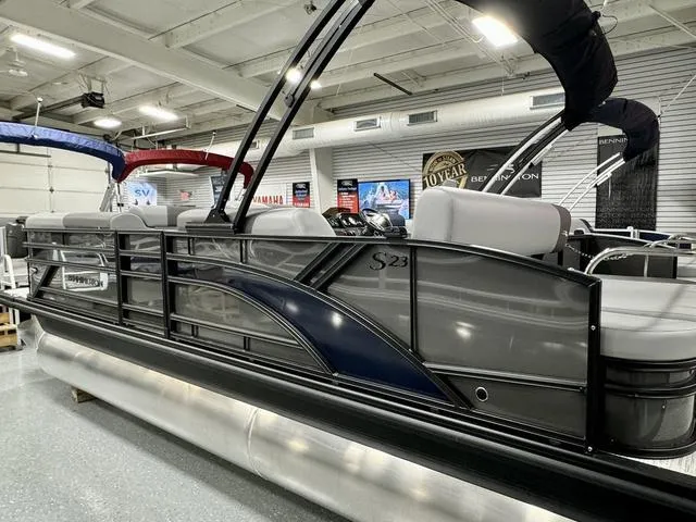Slide: The Image of 2025 Bennington 23 SSB pontoon boat in showroom, sleek design, modern seating. - 24