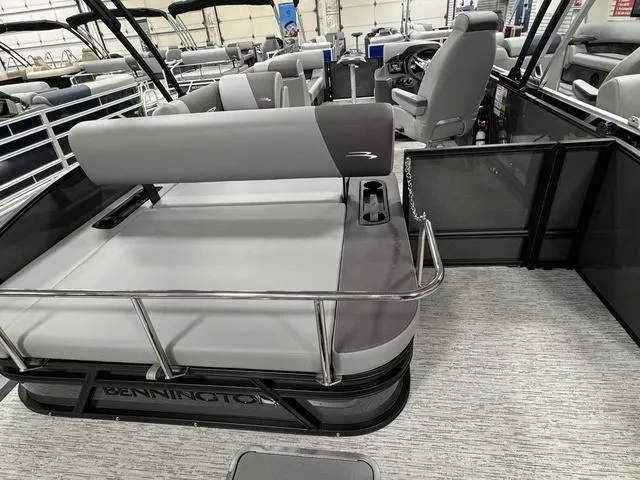 Slide: The Image of 2025 Bennington 23 SSB pontoon boat interior with modern seating and steering console. - 25