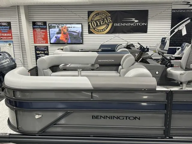 Slide: The Image of 2025 Bennington 23 SSB pontoon boat in showroom, featuring luxurious seating and modern design. - 6