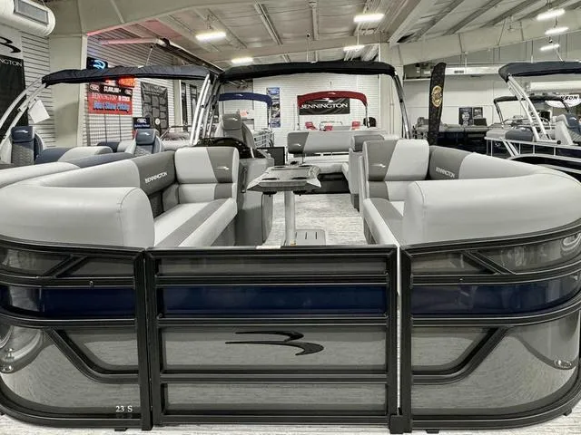 Slide: The Image of 2025 Bennington 23 SSB pontoon boat with sleek gray seating in a showroom. - 8