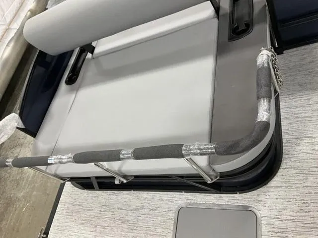 Slide: The Image of 2025 Bennington 23 SSB boat interior with cushioned seating and safety railing. - 10