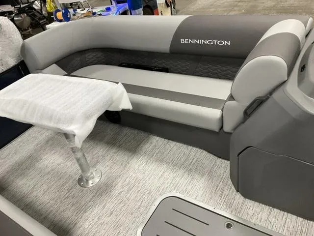 Slide: The Image of 2025 Bennington 23 SSB boat interior with gray seating and table. - 5