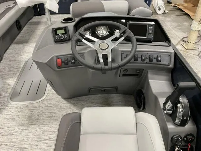 Slide: The Image of 2025 Bennington 23 SSB boat dashboard with steering wheel and control panel. - 6