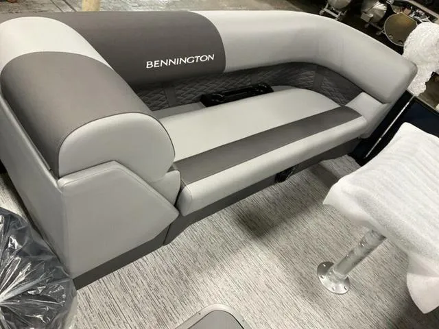 Slide: The Image of 2025 Bennington 23 SSB boat seating, featuring gray and white upholstery with logo. - 8