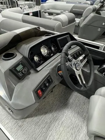 Slide: The Image of 2025 Bennington 22 SSR boat dashboard with modern controls and steering wheel. - 11