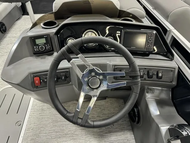 Slide: The Image of 2025 Bennington 22 SSR boat dashboard with steering wheel and control panel. - 13