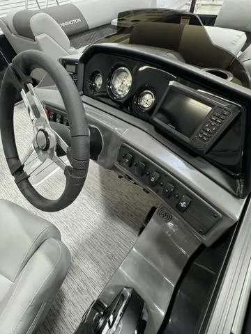Slide: The Image of 2025 Bennington 22 SSR boat dashboard with steering wheel and control panel. - 18