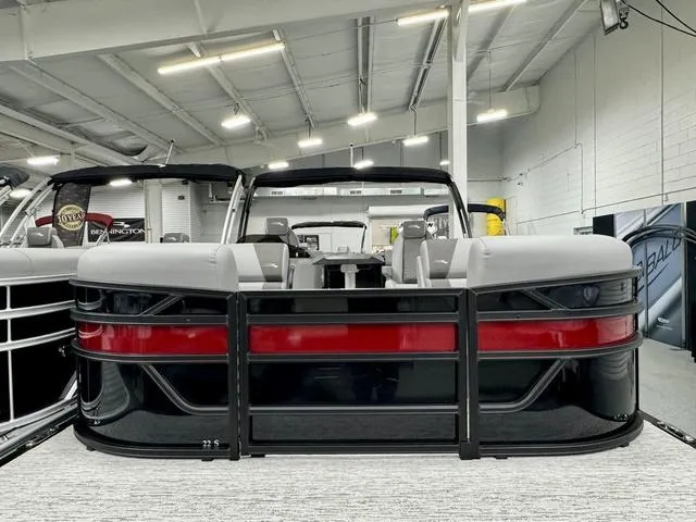 Slide: The Image of 2025 Bennington 22 SSR pontoon boat in showroom, featuring sleek design and modern seating. - 4