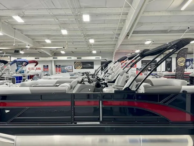 Slide: The Image of 2025 Bennington 22 SSR pontoon boat displayed in a showroom. - 5