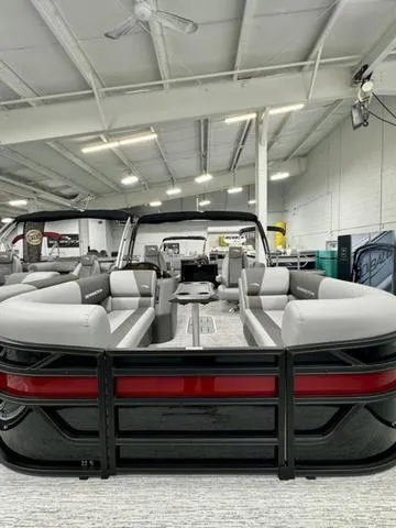 Slide: The Image of 2025 Bennington 22 SSR pontoon boat in showroom, featuring sleek gray seating and modern design. - 6