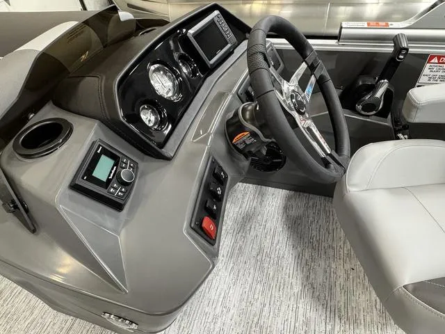 Slide: The Image of Interior view of 2025 Bennington 22 SSB boat dashboard with steering wheel and controls. - 10