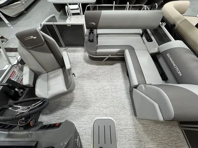 Slide: The Image of 2025 Bennington 22 SSB pontoon boat interior with gray seating and modern design. - 11