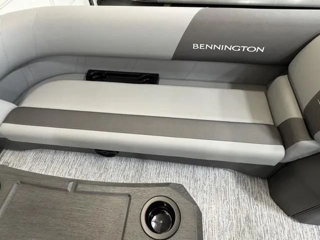 Slide: The Image of 2025 Bennington 22 SSB boat interior with gray seating and cup holder. - 16