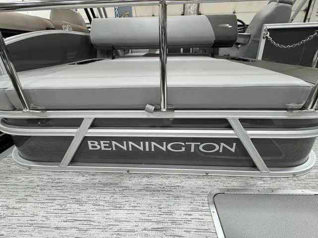 Slide: The Image of 2025 Bennington 22 SSB pontoon boat with sleek gray seating and stylish design. - 19