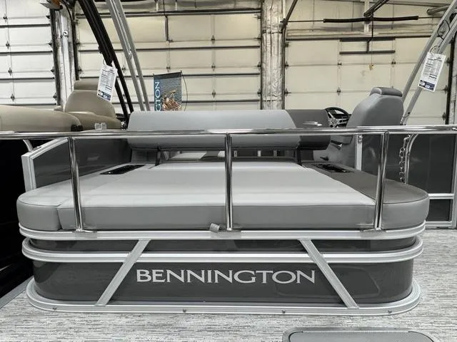 Slide: The Image of 2025 Bennington 22 SSB pontoon boat with sleek gray seating and railing in a showroom. - 21