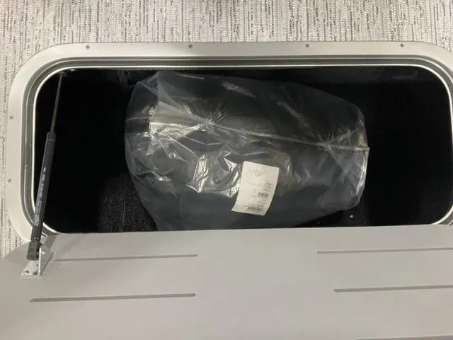 Slide: The Image of Storage compartment of 2025 Bennington 22 SSB boat with packaged item inside. - 22