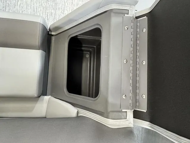 Slide: The Image of 2025 Bennington 22 SSB boat seat storage compartment, open and empty. - 23
