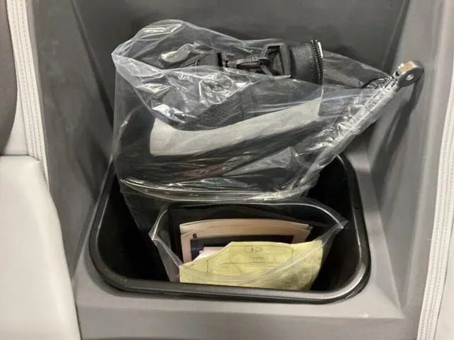 Slide: The Image of Storage compartment in a 2025 Bennington 22 SSB boat with items in plastic bags. - 24