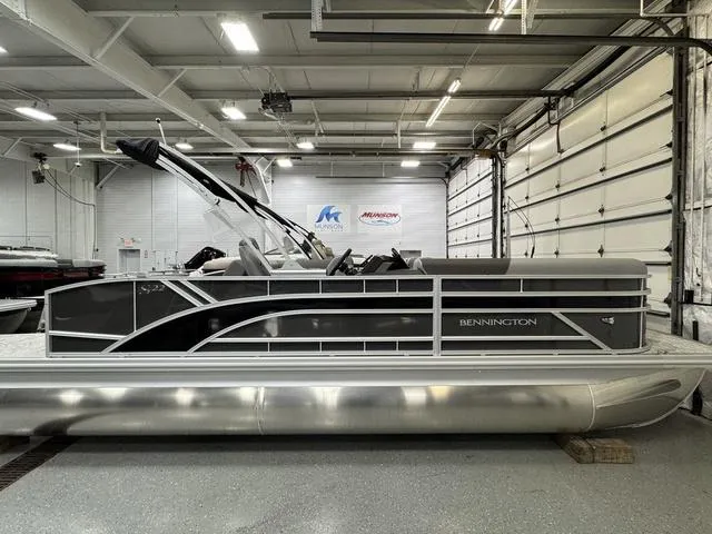 Slide: The Image of 2025 Bennington 22 SSB pontoon boat in a showroom, side view. - 6
