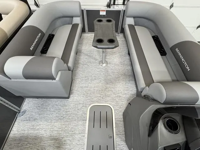 Slide: The Image of 2025 Bennington 22 SSB pontoon boat interior with gray seating and central table. - 9