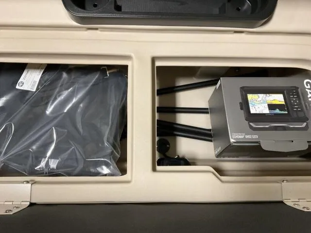Slide: The Image of Storage compartment of 2025 Bennington 22 SSR with Garmin device and accessories. - 10