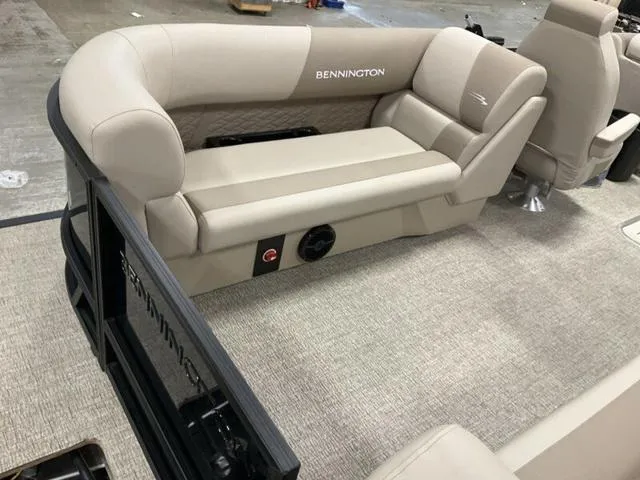 Slide: The Image of 2025 Bennington 22 SSR boat interior with beige seating and carpeted flooring. - 4
