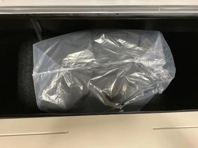Slide: The Image of Plastic-wrapped item inside a compartment of a 2025 Bennington 22 SSR boat. - 9