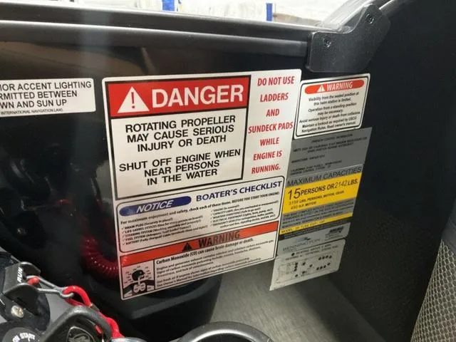 Slide: The Image of Warning labels on a 2025 Bennington M Quad Bench 26 MFB boat. - 7