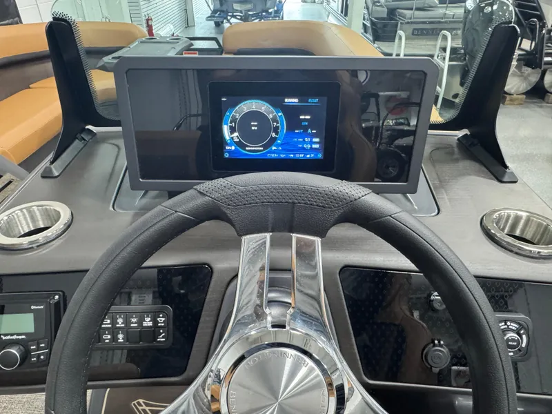 Slide: The Image of 2025 Bennington M Swingback 24 MSB dashboard with digital display and steering wheel. - 10