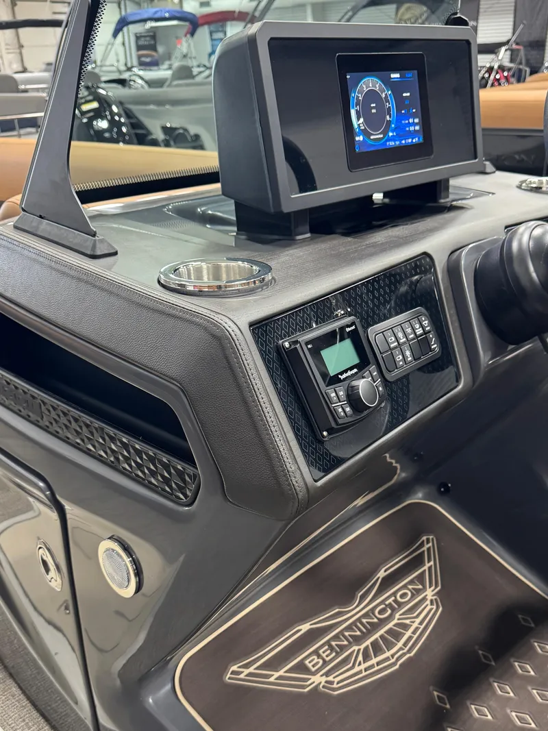 Slide: The Image of 2025 Bennington M Swingback 24 MSB dashboard with digital display and controls. - 11