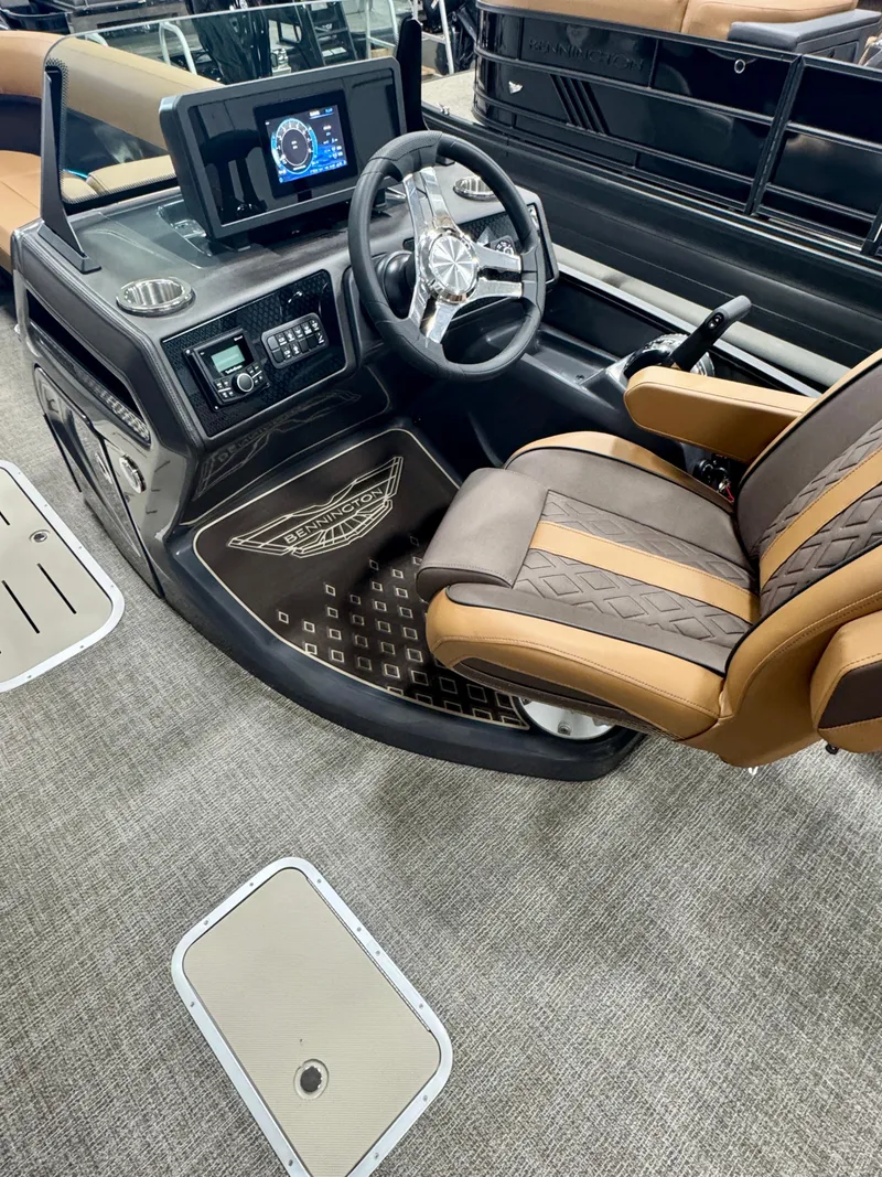 Slide: The Image of 2025 Bennington M Swingback 24 MSB boat interior with modern dashboard and luxurious seating. - 12