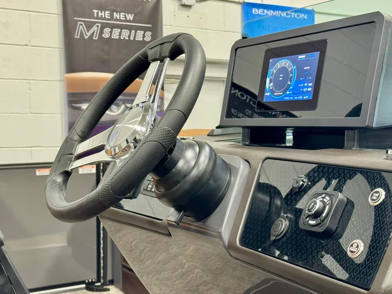 Slide: The Image of 2025 Bennington M Swingback 24 MSB dashboard with steering wheel and digital display. - 13