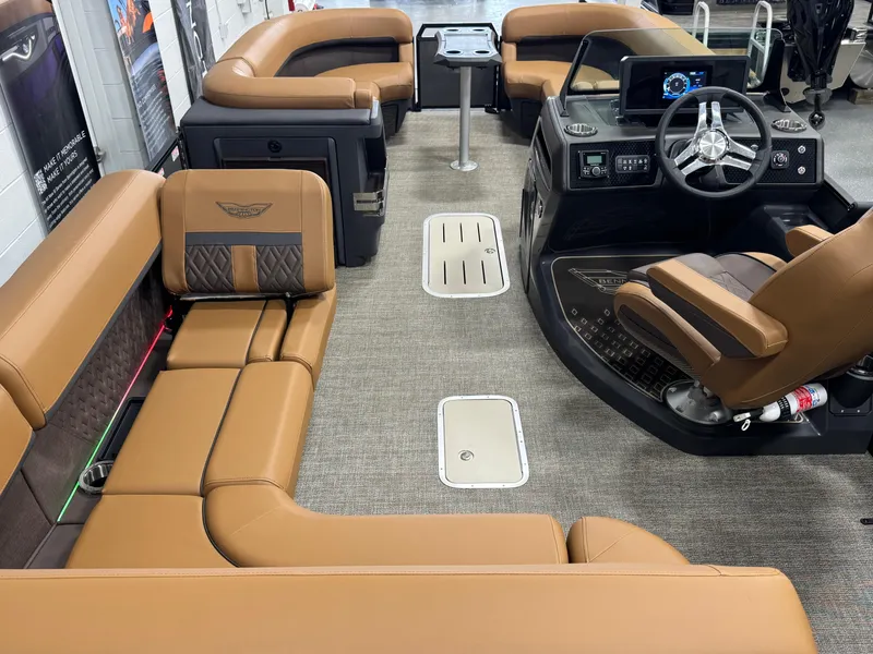 Slide: The Image of 2025 Bennington M Swingback 24 MSB interior with luxurious tan seating and modern helm. - 14