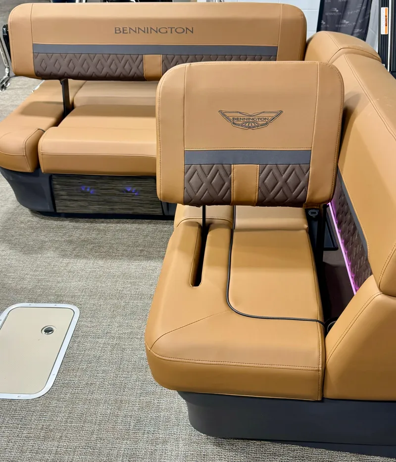 Slide: The Image of 2025 Bennington M Swingback 24 MSB boat interior with luxurious tan seating and elegant design. - 16