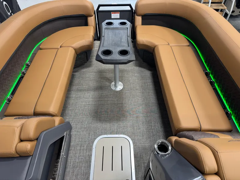 Slide: The Image of 2025 Bennington M Swingback 24 MSB interior with tan seating and green LED lighting. - 17