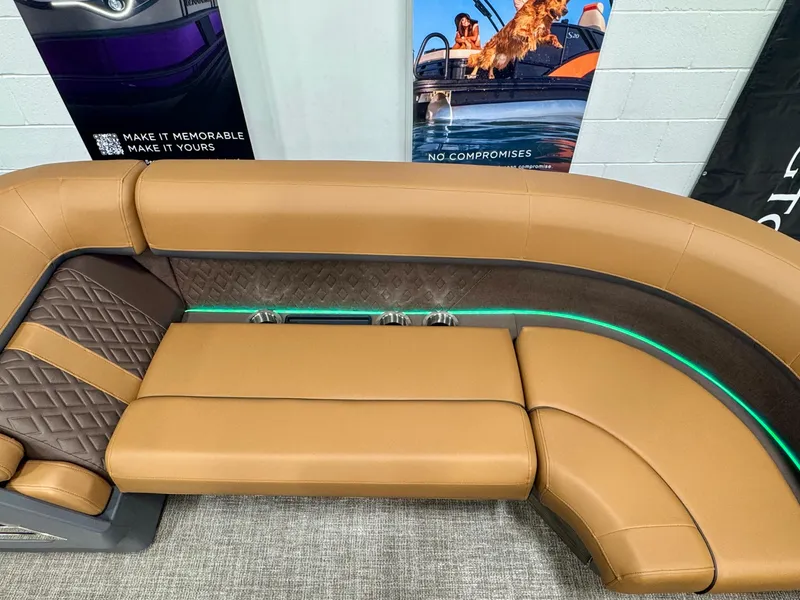 Slide: The Image of 2025 Bennington M Swingback 24 MSB boat interior with tan leather seating and modern design. - 21