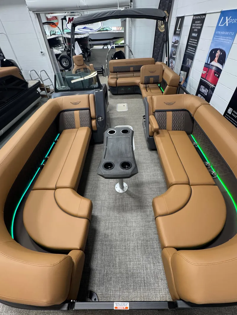 Slide: The Image of 2025 Bennington M Swingback 24 MSB boat interior with tan seating and modern design. - 24