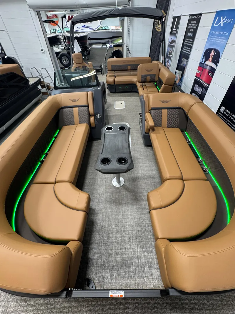 Slide: The Image of 2025 Bennington M Swingback 24 MSB pontoon boat with luxurious seating and ambient lighting. - 25