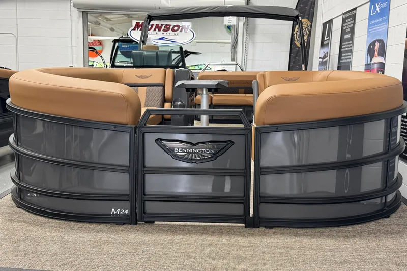 Slide: The Image of 2025 Bennington M Swingback 24 MSB pontoon boat with tan seating in showroom. - 6