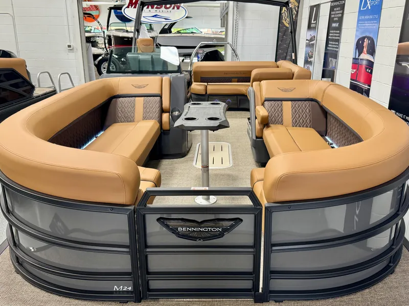 Slide: The Image of 2025 Bennington M Swingback 24 MSB pontoon boat with luxurious tan seating and modern design. - 7