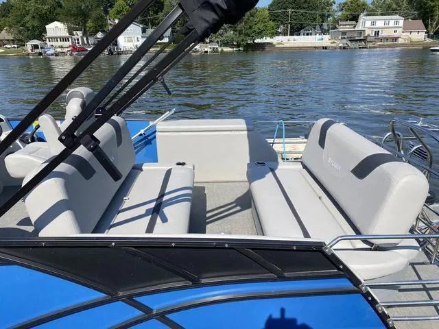 Slide: The Image of 2021 Sylvan L-3 DLZ pontoon boat with spacious seating on a sunny lake. - 10