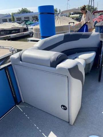 Slide: The Image of 2021 Sylvan L-3 DLZ pontoon boat with gray seating at a marina. - 3