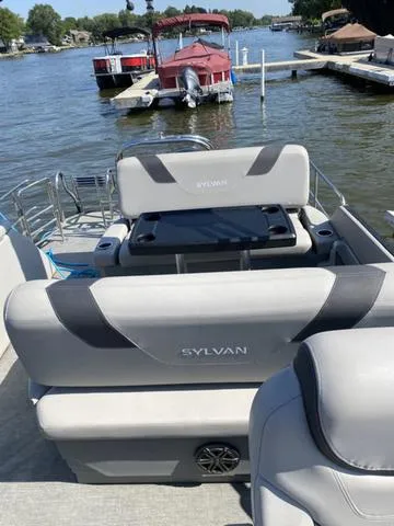 Slide: The Image of 2021 Sylvan L-3 DLZ pontoon boat on a sunny lake with docks. - 4