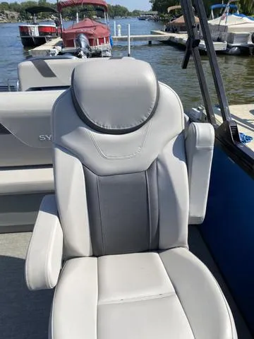 Slide: The Image of 2021 Sylvan L-3 DLZ boat seat, gray upholstery, docked by the water. - 5