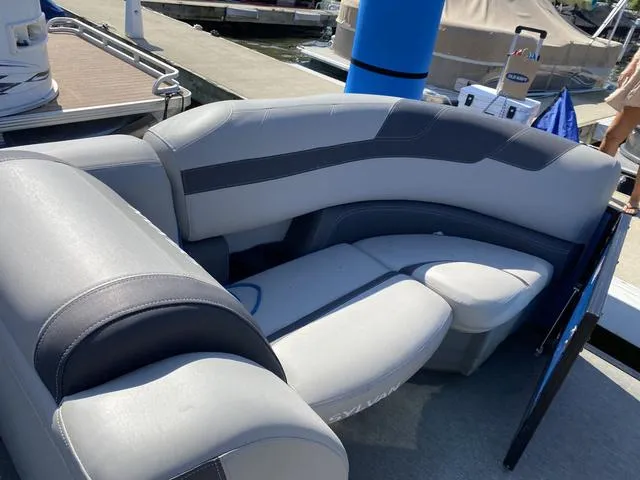 Slide: The Image of 2021 Sylvan L-3 DLZ boat seating area with gray upholstery at a dock. - 6